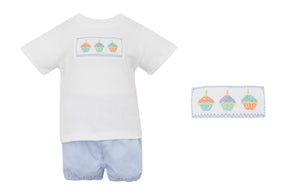 Celebrate your little boy's birthday with our Light Blue Gingham Short Set! This adorable outfit features a short sleeve white smocked tee with hand smocked cupcakes across the bodice and matching gingham shorts. Perfect for any birthday party, it's a sweet and stylish way to dress up your little one.