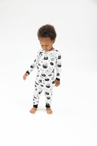 Dress your little one in spooky style with our Black & White Long Sleeve Halloween Pajama Set! Designed by Angel Dear, this adorable pajama set features Halloween-inspired designs in classic black and white colors. Your toddler will love the softness of this material, making bedtime even more comfortable. Get your little ghoul ready for a good night's sleep! These are a snug fit!