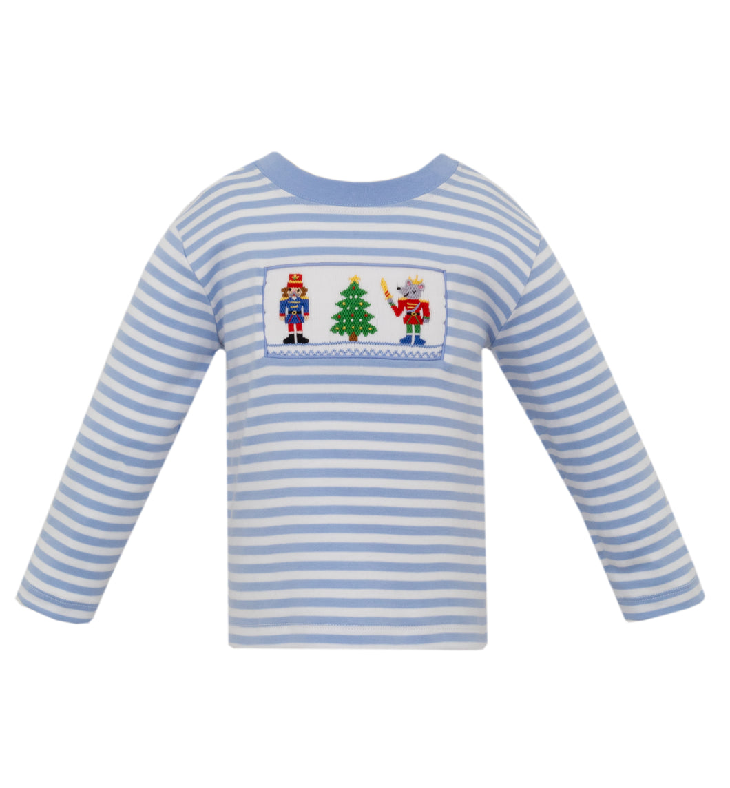 The Nutcracker Knit Play Tee, perfect for your little one's playtime! Made from soft, periwinkle blue stripe material, this shirt features a smocked Nutcracker detail that adds a touch of fun and whimsy. Let your toddler's imagination run wild in this comfortable and stylish play tee from Anavini.