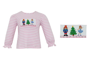 The Nutcracker Knit Tee, perfect for your little one's playtime! Made from soft, pink and white stripe material, this shirt features a smocked Nutcracker detail that adds a touch of fun and whimsy. Let your toddler's imagination run wild in this comfortable and stylish play tee from Anavini.