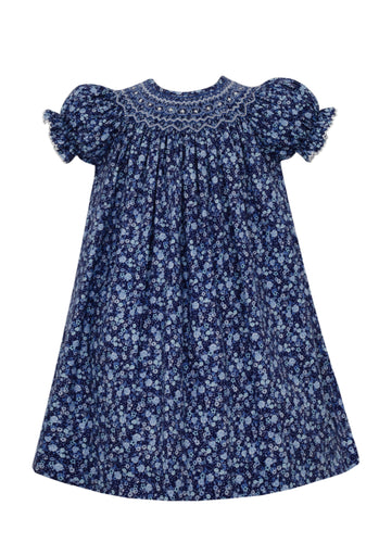 This charming toddler's dress from Anavini features delicate smocked details and a beautiful white and blue floral motif. Perfect for special occasions or everyday wear, this Royal Blue Liberty Floral Bishop dress will make your little one feel like a princess.