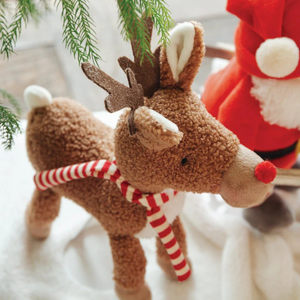 Rudie the Reindeer, the festive stuffed animal plush pal! With warm textured frown fur, soft white belly, and adorable red nose, Rudie is ready to light up your holiday season. Adorned with a charming red and white striped scarf and cute antlers, this delightful reindeer is perfect for snuggling and spreading holiday cheer! Embrace the festive fun with Rudie and let your celebrations be filled with cuddles and cheer!