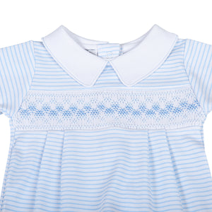 This classically adorable Lily &amp; Logan Smocked Collared Footie is perfect infant boys. Made by Magnolia Baby, it features delicate smocking and a cute blue detail, making it both stylish and comfortable. Keep your little one cozy and stylish in this sweet footie.