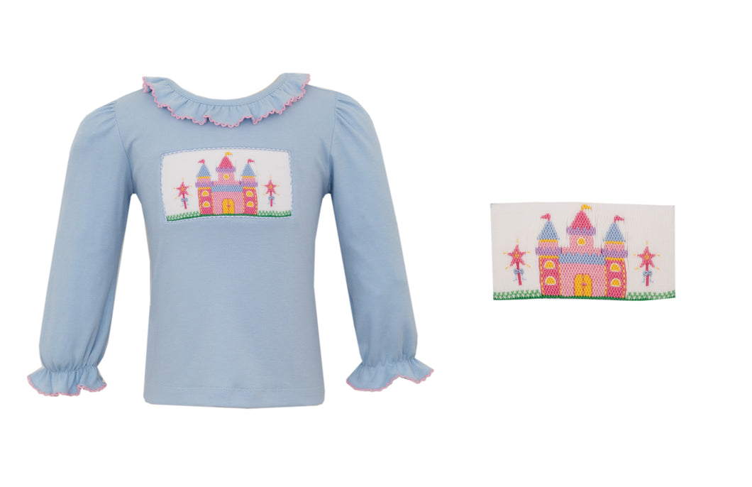 Elevate your little girl's wardrobe with our Girls Castle Smocked Long Sleeve Tunic. Featuring a royal princess castle design smocked onto a light blue knit fabric, this top is fit for a princess. The long sleeves provide warmth and comfort, making it perfect for any occasion.