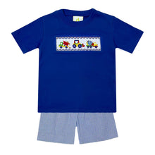 Load image into Gallery viewer, The Construction Smocked Play Tee is perfect for little ones who love to play with construction vehicles. This royal blue tee features a detailed smocked design of a construction vehicle on the front, making it both fun and stylish. Pair it with our Blue Striped Seersucker Leo Shorts for a complete look for toddler boys.
