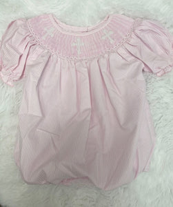 Get ready for Easter Sunday or any religious event with the Crissy Cross Bubble from Shop Teeta! This stunning bubble features pink and white pinstripes and a smocked collar adorned with white crosses. Look and feel your best with this elegant and versatile bubble.