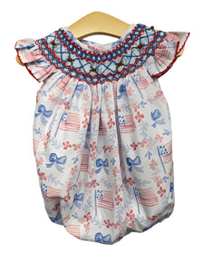 Get your little one ready for 4th of July with the Annie Patriotic Bow Bishop Bubble from Shop Teeta. Featuring a beautiful USA flag motif and a smocked bishop neckline, this bubble is perfect for showing off her patriotic spirit. Made with quality fabric, she'll stay comfortable and stylish all day long.