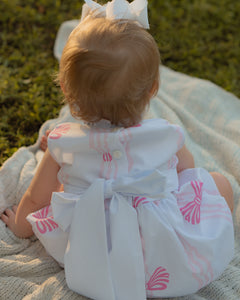 Dress your infant girl in the adorable Ada Ribbons &amp; Bows Bubble from The Yellow Lamb. This charming bubble style outfit features a pink bow and ribbon design and a back bow tie. Don't forget to grab the matching Ada Ribbons &amp; Bows Dress for a sibling set!