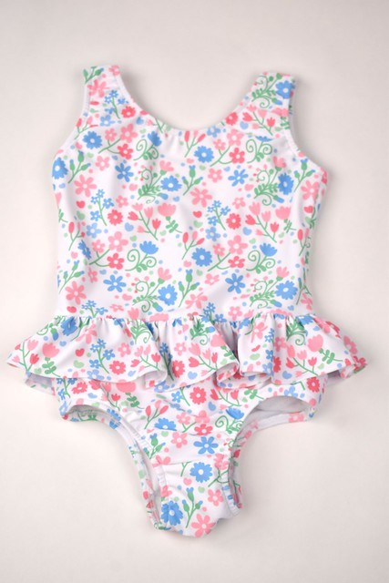 Get ready to make a splash with our Floral Ruffle One Piece Swimsuit! Designed by Funtasia Too, this adorable swimsuit features a cute pink, blue and green floral design on a white background and ruffle waist accent.