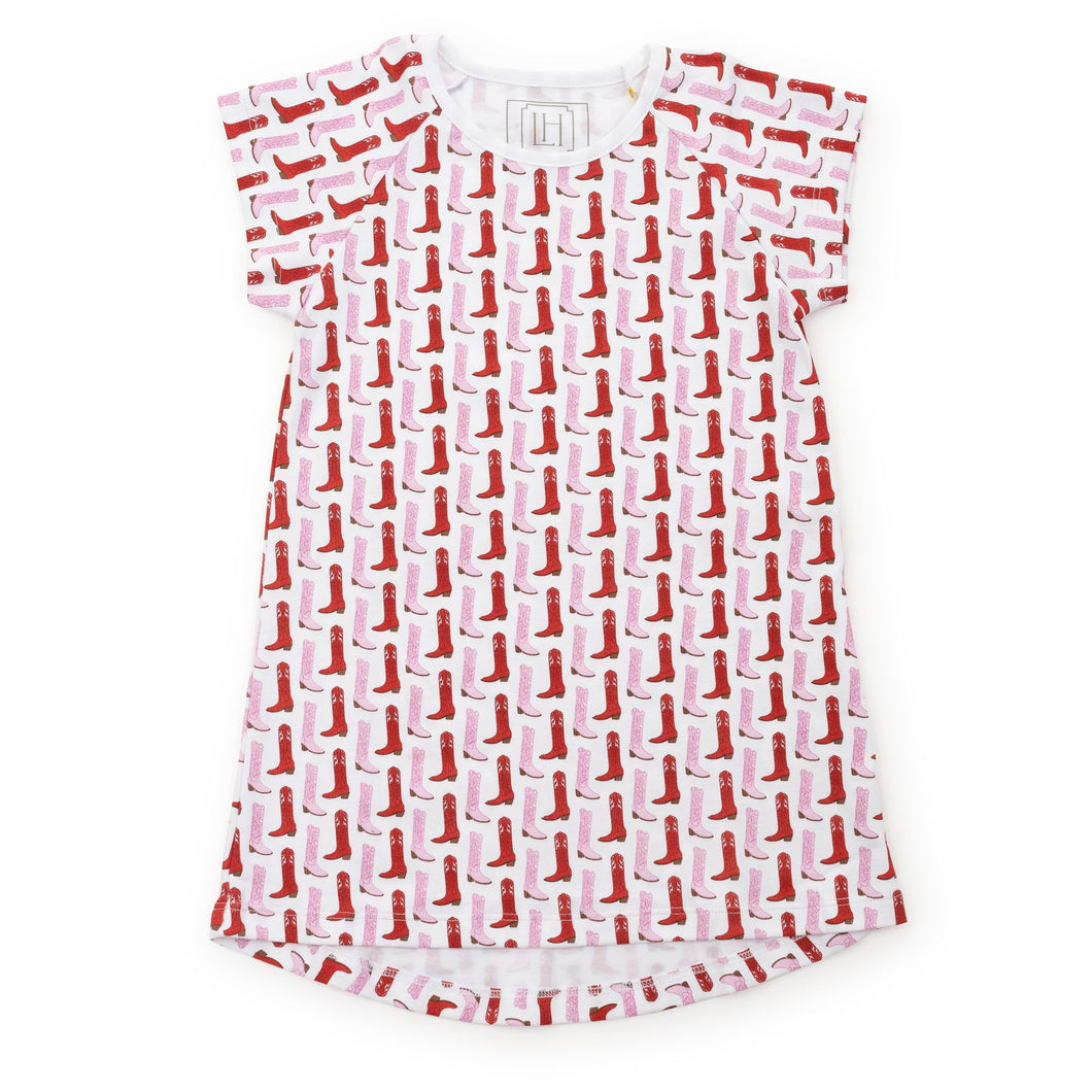 Get your little cowgirl ready for bedtime with the City Boots Sadie Short Sleeve Pajama Shirt Dress. Made by Lila and Hayes, this pajama dress features a fun and colorful design of pink and red cowgirl boots. With short sleeves and a comfortable fit, it's perfect for a good night's sleep.