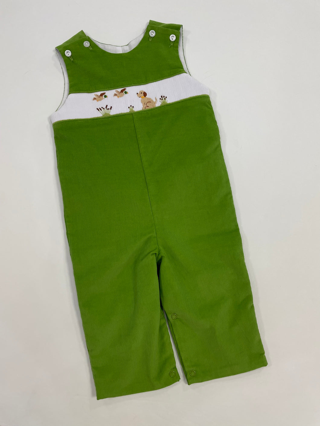 This classic corduroy infant boy jon jon is a must-have for any toddler boy's wardrobe. The adorable flying ducks and dog smocked detail along the front adds a charming touch to any occasion. Made with high-quality material, this jon jon is both comfortable and stylish. A perfect addition to your little one's outfits. Matching sibling sets available